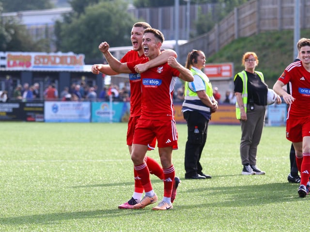 Man of the match Bailey Gooda hugs match-winner Lewis Maloney.