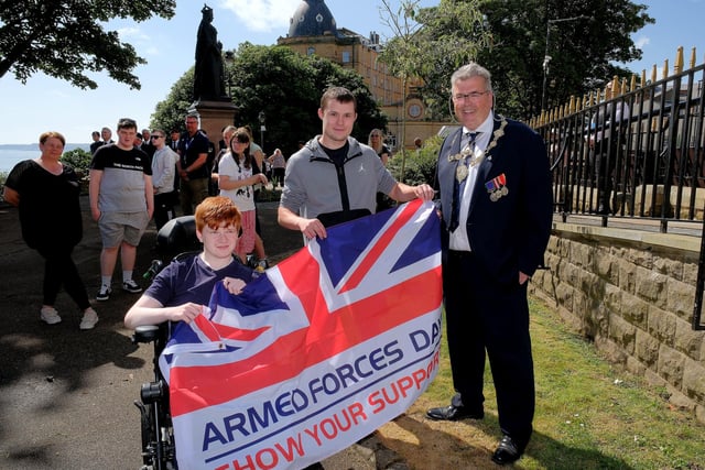 Mayor John Ritchie hands over The Armed Forces Flag to Springhead pupils Jaydon Culley and Travis McCallion