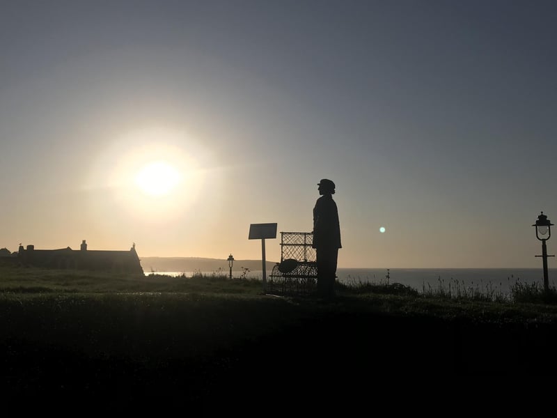 Dora Walker sculpture silhouetted against the sky in Whitby, by Carol Cull.
