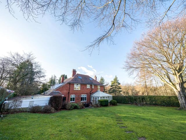 A rear view of the property with its large, lawned garden.