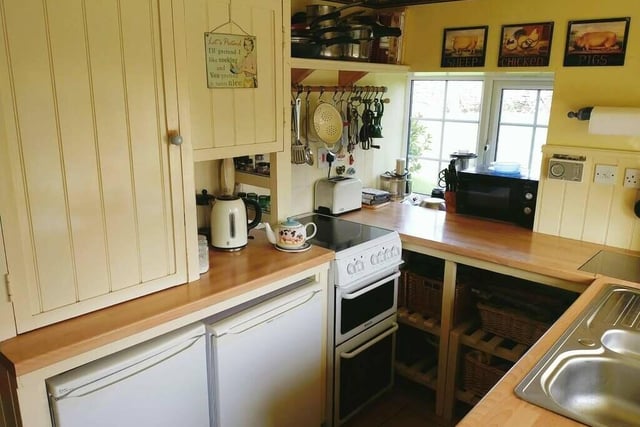 Part of the kitchen, with fitted cupboards and shelving.