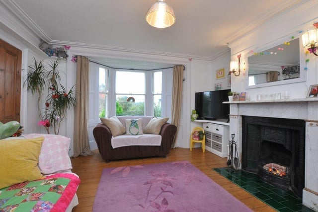 One of the bay-fronted reception rooms, with a feature fireplace.
