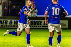Bradley Fewster, left, earned Whitby Town their first draw of season at FC United of Manchester. PHOTO BY BRIAN MURFIELD