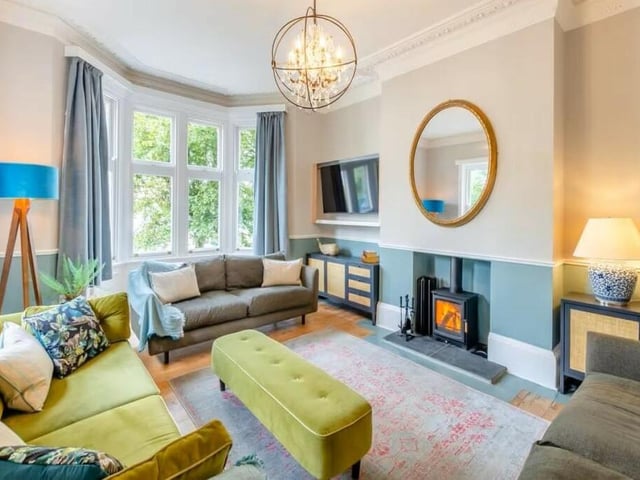 A bay-fronted lounge has a feature fireplace with warming stove.