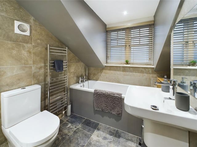 Section of the family bathroom that also has a walk-in shower unit.