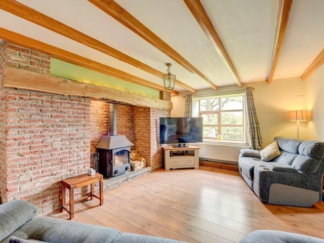 The beamed lounge with rustic feature fireplace.