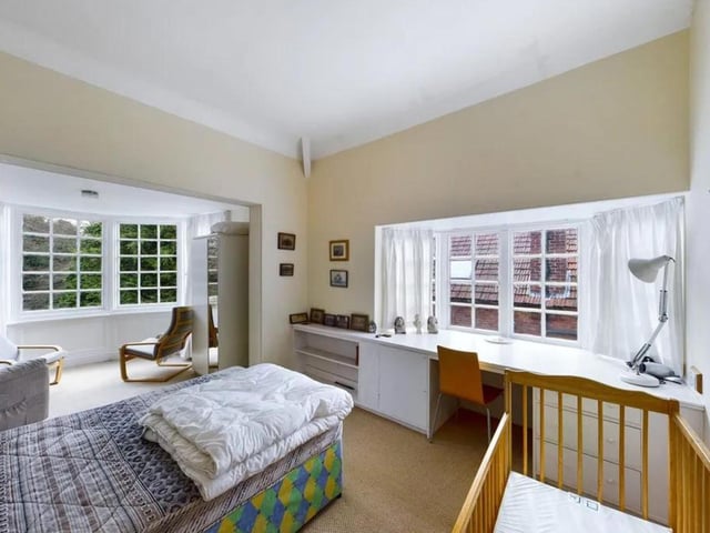This bedroom has a little room to the side of it, making it larger.