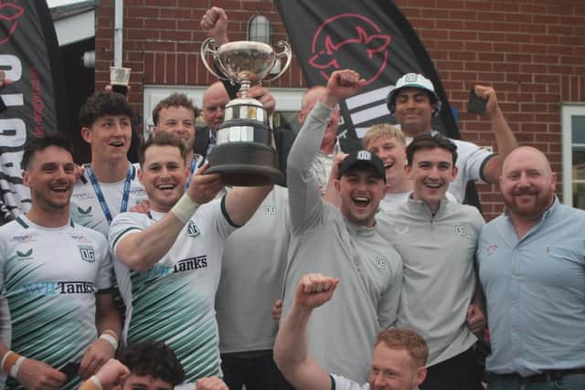 Old Grovians celebrate after receiving the Fowler Trophy from Warrendale Wagyu director James Thornton (right).