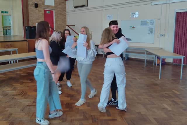 Students at Filey School embrace as they pick up their GCSE exam results.