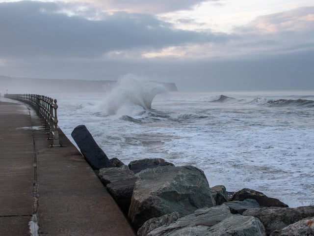 Waves crash in on Whitby seafront, by Deborah McCarthy.