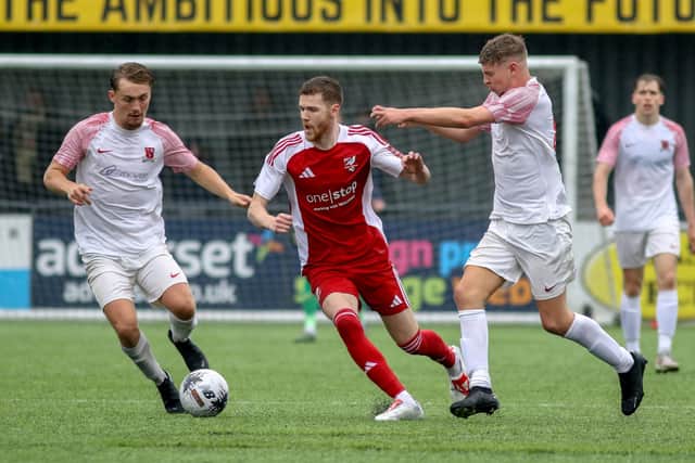 Kieran Glynn weaves his way through the Selby Town midfield.