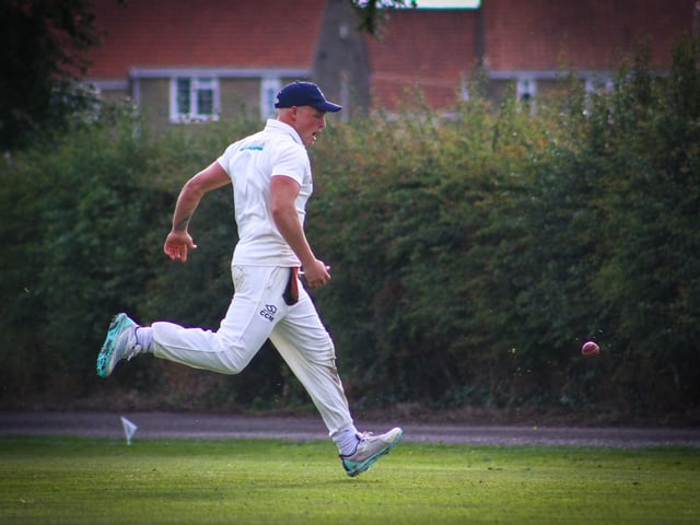 A fielder looks to reel the ball back in.