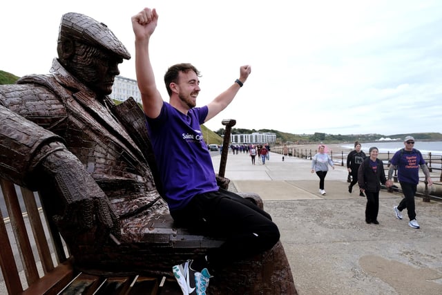 Hospice staff member Tom Thornton cheers on the walkers.
picture: Richard Ponter
