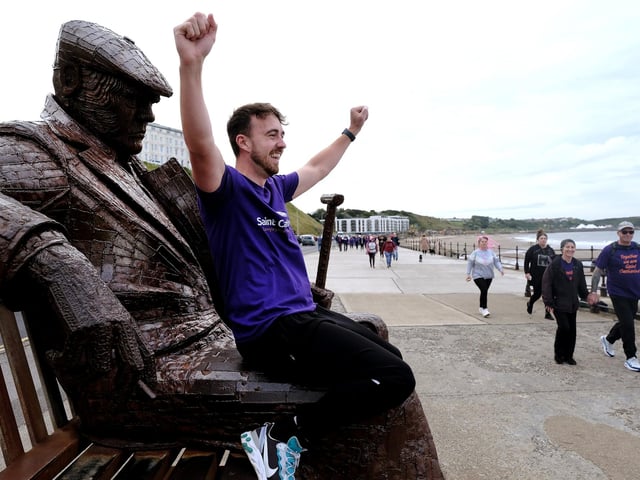 Hospice staff member Tom Thornton cheers on the walkers.
picture: Richard Ponter