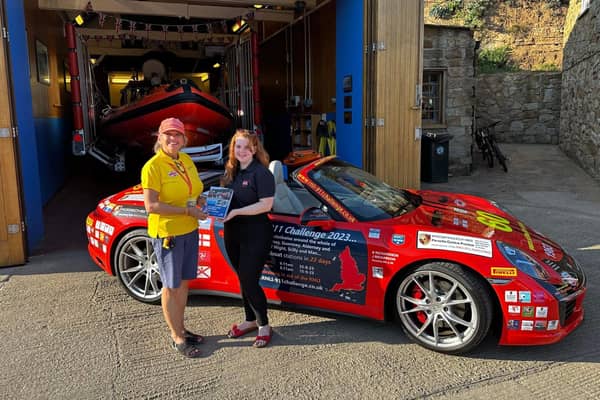 Belinda Richardson is presented with two gifts from the station, a station lapel badge and station history book by the late Grant McKee.
picture: RNLI