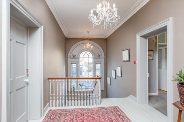 An impressive arched window lights up the stairs and landing.