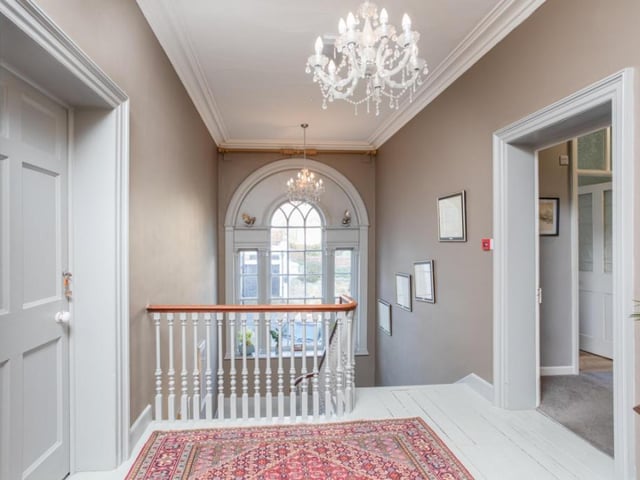 An impressive arched window lights up the stairs and landing.