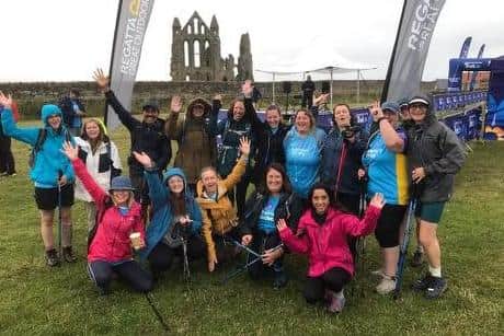 |Staff from Tees, Esk and Wear Valleys NHS Foundation Trust celebrating at the end of the 26-mile hike, at Whitby Abbey.