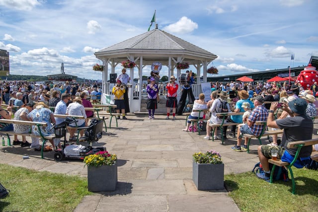 Crowds gather at the bandstand to enjoy music from the Fat Cat Brass band in the sunshine on the third day of the show