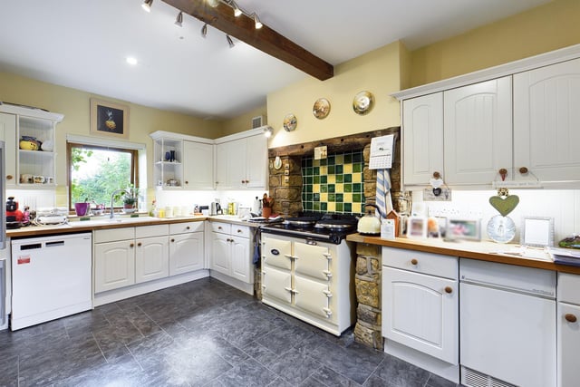 The breakfast kitchen has fitted units with integrated appliances.