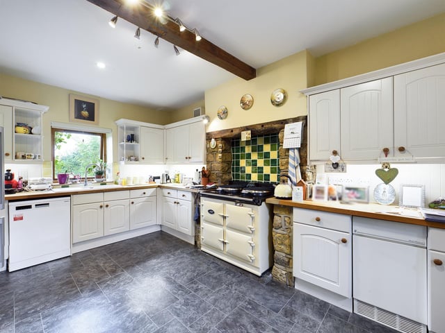 The breakfast kitchen has fitted units with integrated appliances.