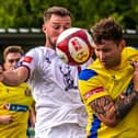 Kev Burgess of Marske United heads the ball away from Lewis Hawkins
