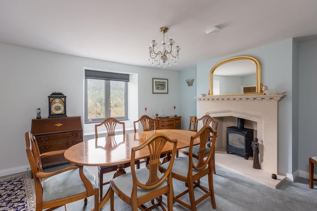 A good size dining room with feature fireplace and stove.