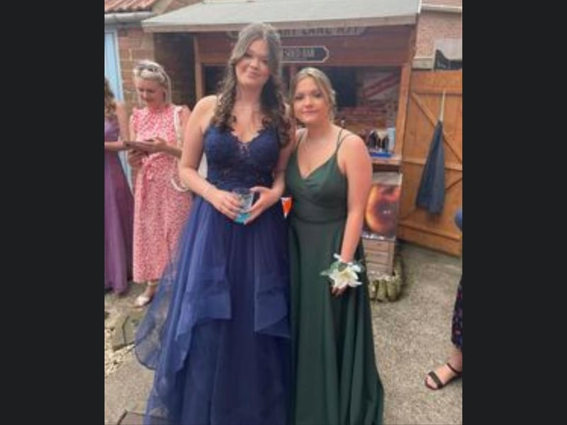 These two friends are looking fabulous in their prom dresses.