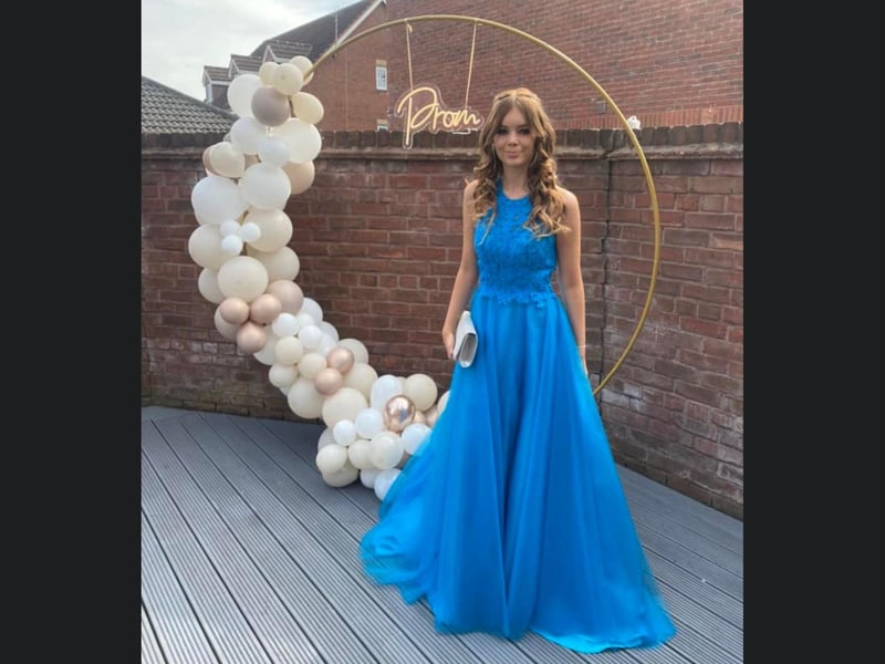 Lily looks beautiful in front of a gorgeous backdrop.