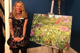 Christine Wilson with her photo of the garden which won 3rd place out of 90 entries.