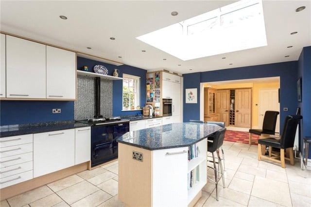 A recently updated kitchen has modern units with a central island.