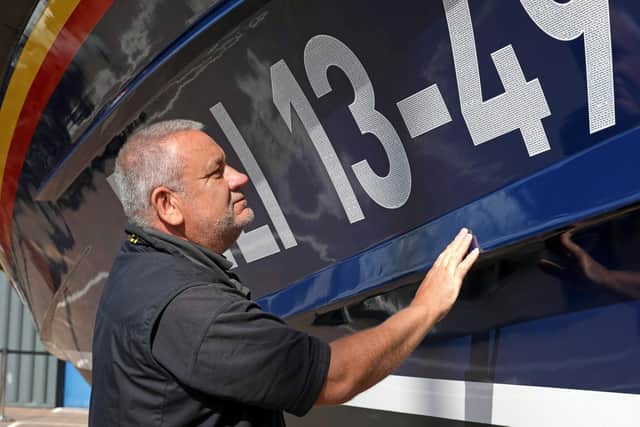 Whitby RNLI coxswain Howard Fields with the new Shannon class boat in Poole.