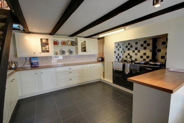 The dining kitchen has modern fitted units and an oil-fired Aga stove, with electric oven and hob.