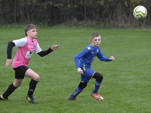 Ayton Under-13s (pink kit) and Eastfield Under-13s keep their eyes on the ball in the league match