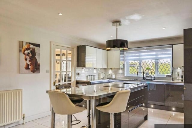 The sleek, modern kitchen has a large central island.