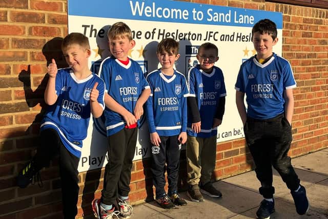 Heslerton's Comets players show off their new kit.