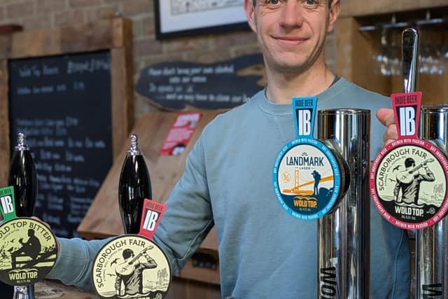 Alex Balchin with the Indie Beer mark pump clips in the Wold Top bar.