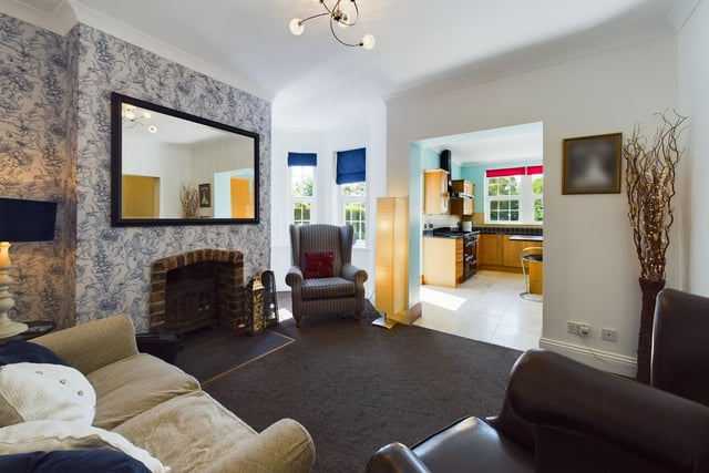 A cosy snug with brick fireplace and wood burning stove.