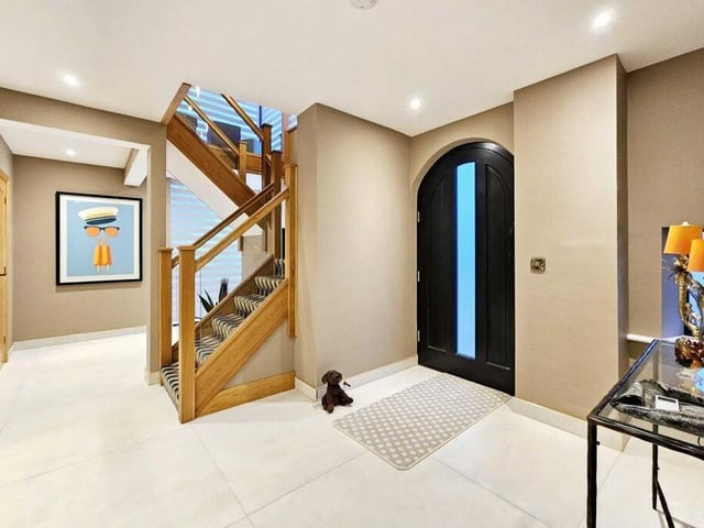 A light and airy entrance hall with feature staircase to a gallery landing.
