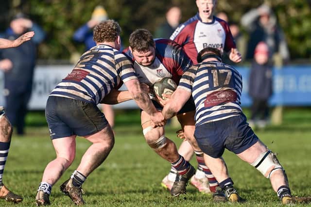 Two Pocklington players try to halt the progress of Vytautas Mudingis. Photo by Andy Standing
