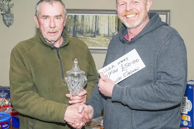 WSAA Christmas Match Heaviest Fish fell to Denis Thompson, Lythe, 4 lb 3 oz, presented the Michael Deadman Memorial Trophy, and £50 by Rich Deadman, right. Photo by Peter Horbury