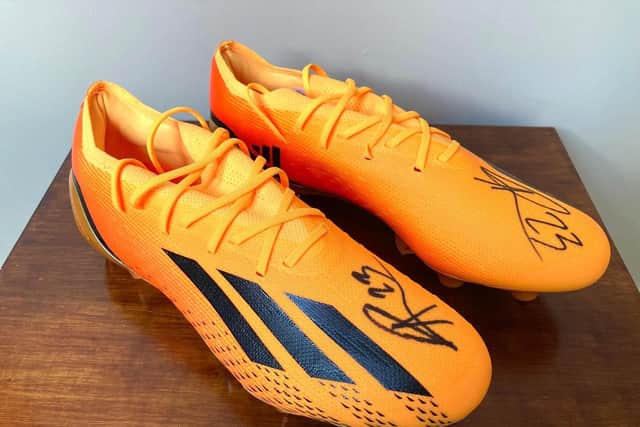 A chance to win football boots signed by England and Arsenal WFC forward, Alessia Russo