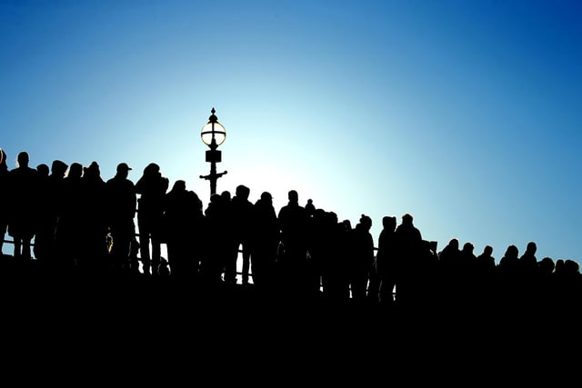 Silhouette of the watching crowd on Whitby's West Pier.