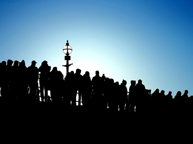 Silhouette of the watching crowd on Whitby's West Pier.