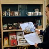 Beccy Roberts, supervisor at Malton Library, looking at the bespoke 2025 Pickering and Malton calendar