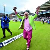 BBC radio commentator Henry Blofeld does a lap of honour after finishing his final radio commentary on the third day of the third international Test match between England and West Indies at Lord's cricket ground in London on September 9, 2017