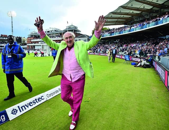 BBC radio commentator Henry Blofeld does a lap of honour after finishing his final radio commentary on the third day of the third international Test match between England and West Indies at Lord's cricket ground in London on September 9, 2017