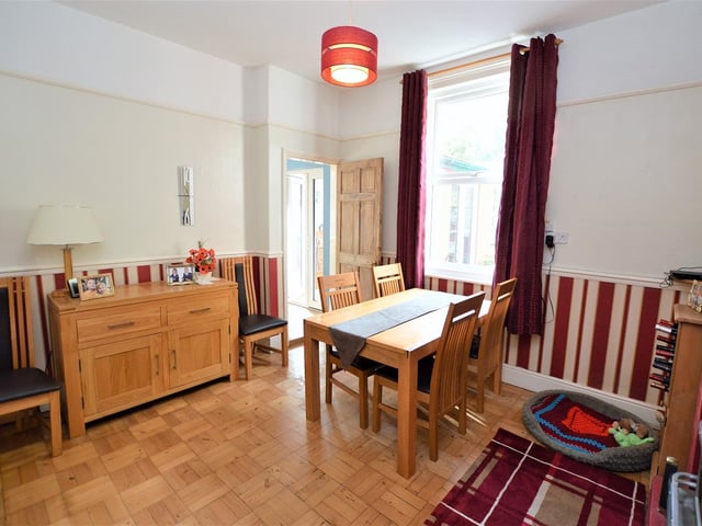 The dining room. Original features in the house include floors, panelling, cornicing, high skirting boards and ornate windows.