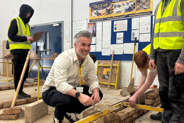 Mayor Skaith tries his hand at brick-laying
