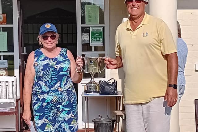 Sue Holdsworth and Chris Dobson hold the trophy aloft at Bridlington Bay.